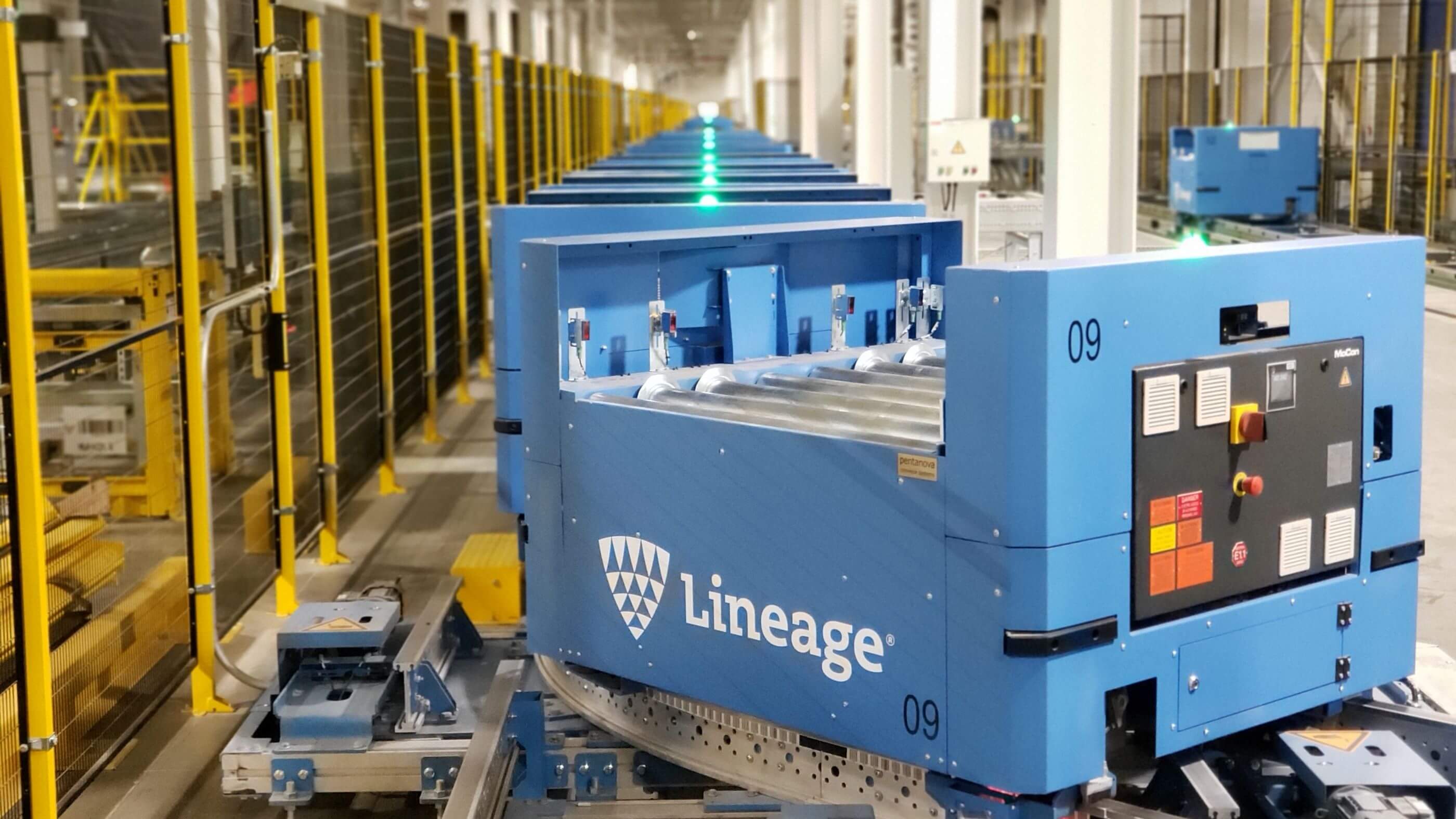 Automated guided cart transporting goods inside a modern, well-organized Lineage cold storage warehouse.