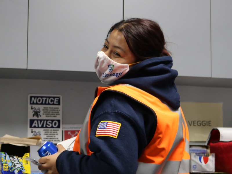 Female worker with mask in break room with pepsi