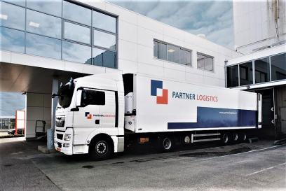 partner logistics truck outside of office building