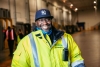 Man wearing high-vis jacket smiling in a Lineage cold storage warehouse