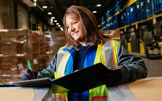 Smiling employee working inside a warehouse
